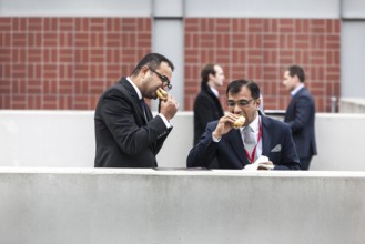 DEU Germany Germany Berlin International Tourism Exchange ITB. Bratwurst eater during lunch break
