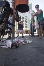 DEU Germany Germany Berlin tourist points to defective trash can at Checkpoint Charlie