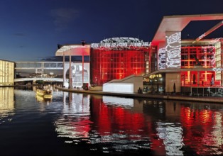 Illuminated Paul Löbe House and Marie Elisabeth Lüders House with the Spree River in the evening,