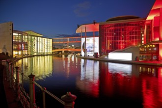 Illuminated Paul Löbe House and Marie Elisabeth Lüders House with the Spree River in the evening,
