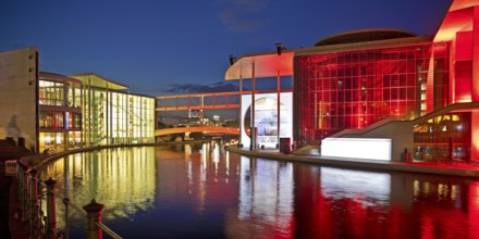 Illuminated Paul Löbe House and Marie Elisabeth Lüders House with the Spree River in the evening,