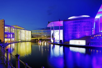 Illuminated Paul Löbe House and Marie Elisabeth Lüders House with the Spree River in the evening,