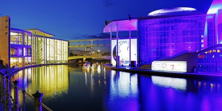 Illuminated Paul Löbe House and Marie Elisabeth Lüders House with the Spree River in the evening,