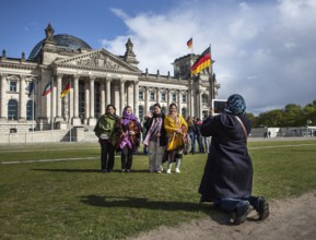 DEU Germany Germany Berlin Tourists, woman from Bangladesh, take pictures of themselves in front of