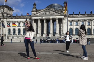 DEU Germany Germany Berlin Kazakh tourists take pictures of themselves in front of the Reichstag