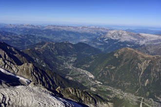 View from the Aiguille du Midi mountain station observation deck into the valley with the city,