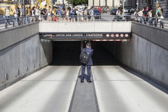 DEU Germany Germany Berlin A man stands in the driveway of a parking garage in Berlin-Mitte while a