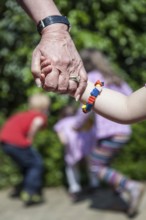 DEU Germany Germany Pattensen Old hand holding young hand in a multi-generation house in Pattensen