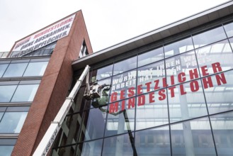 DEU Germany Germany Berlin Window cleaner on the façade of the Verdi headquarters, where an