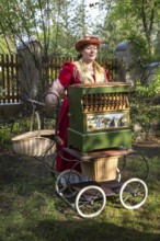 DEU Germany Germany Berlin An organ box woman plays for wedding guests during a reception in the