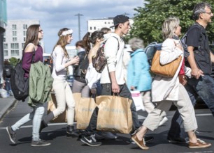 DEU Germany Germany Berlin Young people walk across a pedestrian crossing at Potsdamer Platz with