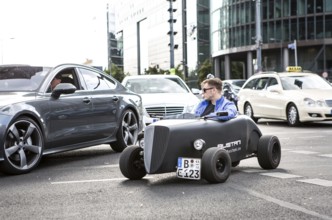 DEU Germany Germany Berlin A mini hot rod driver in traffic at Potsdamer Platz