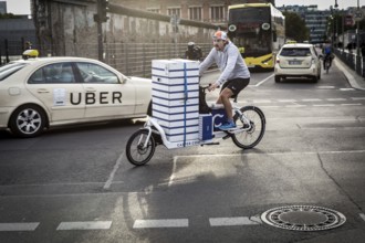 DEU Germany Germany Berlin courier driver traveling with cargo bike in the capital