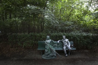 DEU Germany Germany Berlin Two performers take a break on a bench between the Reichstag and the