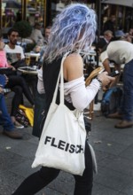 DEU Germany Germany Berlin Woman with blue-dyed hair wears a cloth bag with the inscription Flesh