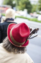 DEU Germany Germany Berlin Woman wearing red hat decorated with feathers