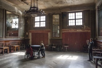 DEU Germany Germany Berlin Visitor films two woman playing a piano in the Hall of Mirrors at