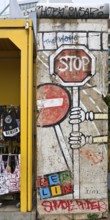 Old telephone box and painted piece of the Berlin Wall, gift shop Berlin loves you, Zimmerstraße,