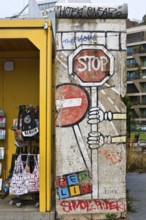 Old telephone box and painted piece of the Berlin Wall, gift shop Berlin loves you, Zimmerstraße,
