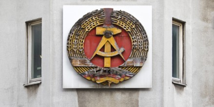Old building of the Wall Museum — Museum Haus am Checkpoint Charlie with old GDR coat of arms,