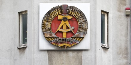 Old building of the Wall Museum — Museum Haus am Checkpoint Charlie with old GDR coat of arms,
