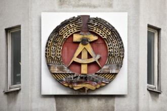 Old building of the Wall Museum — Museum Haus am Checkpoint Charlie with old GDR coat of arms,