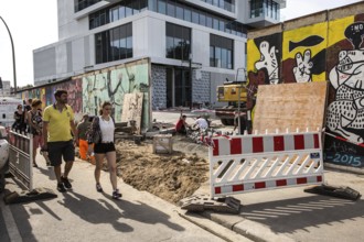 DEU Germany Germany Berlin Tourists pass through the opening in the East-Side Gallery, which was