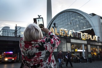 DEU Germany Germany Berlin tourist photographs the TV tower with her tablet