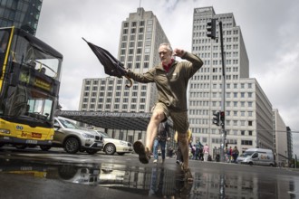 DEU Germany Germany Berlin Pedestrians jump over a cap at Potsdamer Pltz