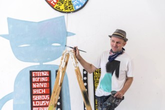DEU Germany Germany Berlin The artist Jim Avignon setting up an exhibition at the 'Retram' gallery
