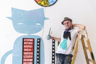 DEU Germany Germany Berlin The artist Jim Avignon setting up an exhibition at the 'Retram' gallery