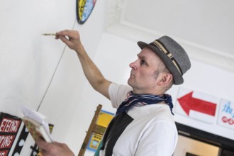 DEU Germany Germany Berlin The artist Jim Avignon setting up an exhibition at the 'Retram' gallery