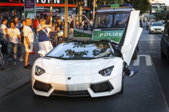 DEU Germany Germany Berlin A Lamborghini sports car is observed or photographed by passers-by on