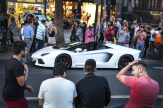 DEU Germany Germany Berlin A Lamborghini sports car is observed or photographed by passers-by on