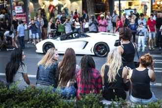 DEU Germany Germany Berlin A Lamborghini sports car is observed or photographed by passers-by on