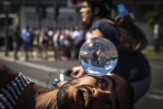 DEU Germany Germany Berlin Juggler with crystal ball works at the intersection opposite the CDU