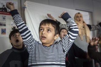 DEU Germany Germany Berlin An animation team entertains refugee children in an asylum center in