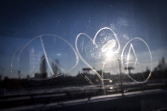 DEU Germany Germany Berlin The symbols of peace, love and anarchy are carved on the window of an