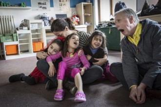 DEU Germany Germany Berlin An animation team entertains refugee children in an asylum center in