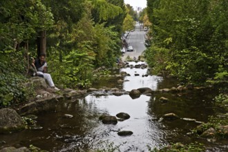 Artificial waterfall in Victoria Park with Großbeerenstraße in the background, Berlin-Kreuzberg,