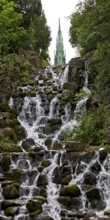 Artificial waterfall in Victoria Park, with the national monument on Kreuzberg in the background,