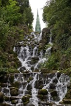 Artificial waterfall in Victoria Park, with the national monument on Kreuzberg in the background,