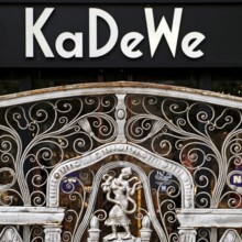 KaDeWe logo, Kaufhaus des Westens, with old forged grid in front of the entrance when the shop is