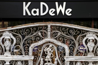 KaDeWe logo, Kaufhaus des Westens, with old forged grid in front of the entrance when the shop is