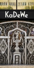 KaDeWe logo, Kaufhaus des Westens, with old forged grid in front of the entrance when the shop is