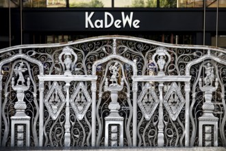 KaDeWe logo, Kaufhaus des Westens, with old forged grid in front of the entrance when the shop is