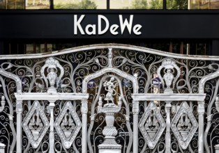 KaDeWe logo, Kaufhaus des Westens, with old forged grid in front of the entrance when the shop is