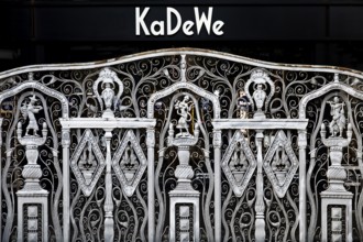 KaDeWe logo, Kaufhaus des Westens, with old forged grid in front of the entrance when the shop is
