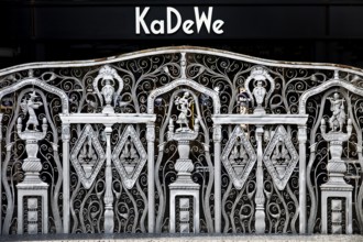 KaDeWe logo, Kaufhaus des Westens, with old forged grid in front of the entrance when the shop is