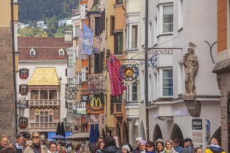 Golden roof, lots of people and historic houses in Herzog-Friedrich-Straße, Altstadt, Innsbruck,